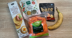 low sodium snacks from left to right, wheat crackers, pumpkin seeds, carrot chips, bare apple chips, banana