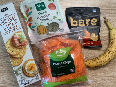 low sodium snacks from left to right, wheat crackers, pumpkin seeds, carrot chips, bare apple chips, banana